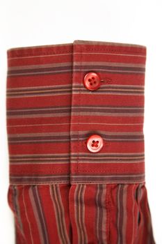 close up of the red cuff from striped shirt