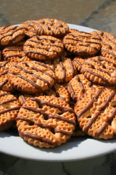 Close up of chocolate striped shortbread cookies on a plate.
