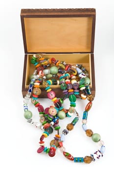 wooden box with fashion beads on white background