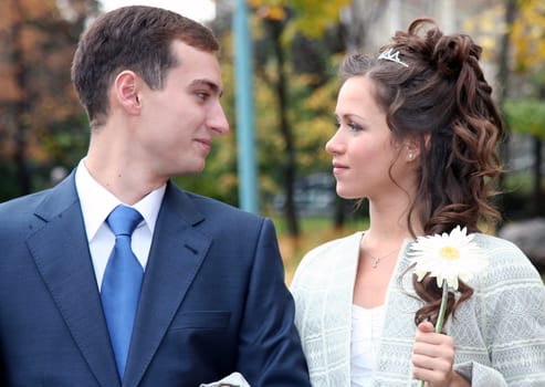 The groom and the bride look each other in the face a loving look