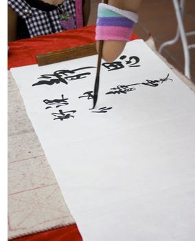 An artist without hand writing Chinese calligraphy.