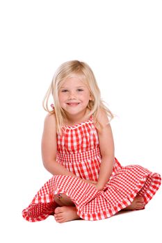 Cute little blond girl sitting on white background