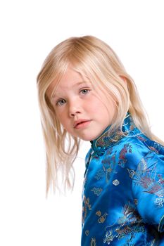 Cute blond four year old girl looking slightly suspicious