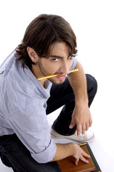 student holding pencil in mouth with white background