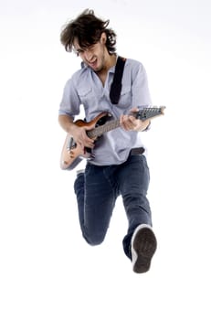 young male jumping high holding his guitar isolated on white background