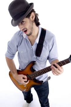 handsome male looking at camera and playing guitar on an isolated white background