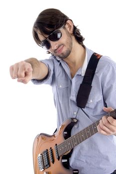 young guitarist with pointing finger against white background