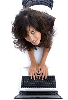 young female lying on floor working on laptop against white background