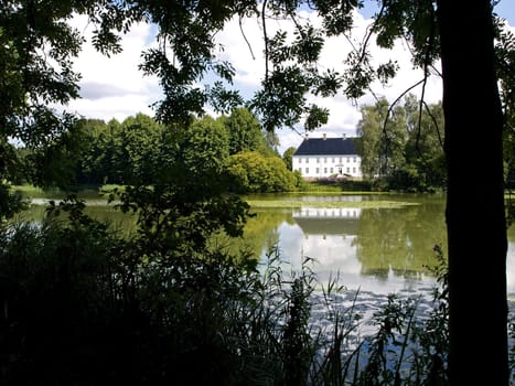 Beautiful landscape of a country mansion house by a lake Denmark