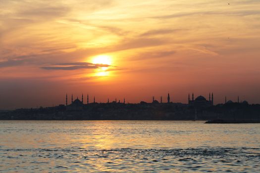 The view of Blue Mosque and Hagia Sofia after sunset across Bosporus. Istanbul, Turkey