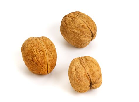 Three whole walnuts isolated on white background