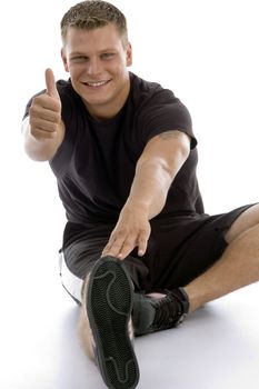 exercising man showing good luck sign on an isolated background