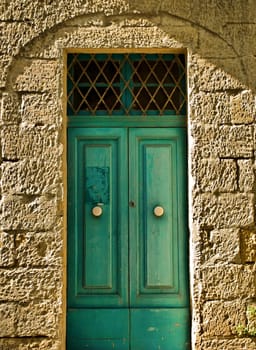 Typical Maltese traditional door in aquamarine colour