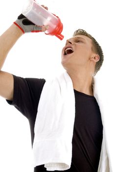 man taking drink while exercise on an isolated background