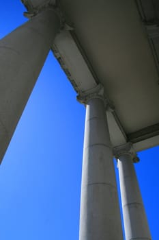 Tall columns over blue sky.
