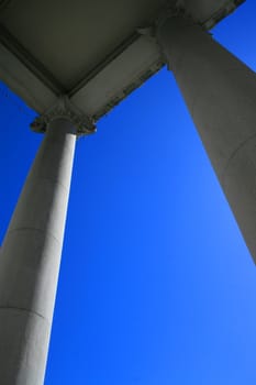 Tall columns over blue sky.
