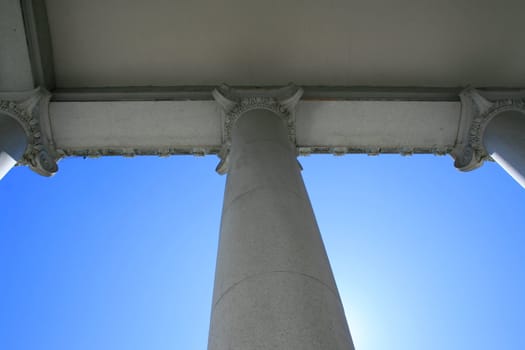 Tall columns over blue sky.
