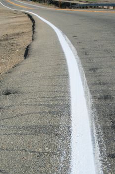 Close up of a white line of a road.
