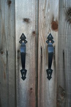 Close up of door knobs on a wooden door.
