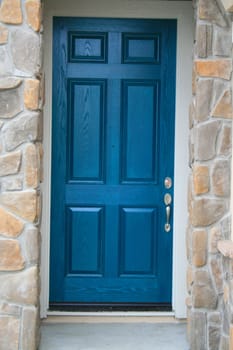 Blue front door in a residential house.
