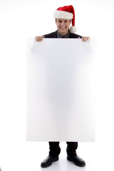 executive wearing christmas hat displaying placard against white background