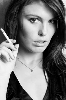 Portrait of beautiful young fashion model smoking a cigarette