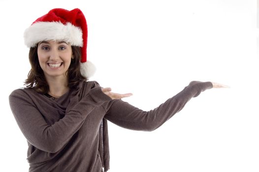 young female in christmas hat with open palms on an isolated white background