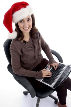 happy teenager busy with laptop looking at camera isolated on white background