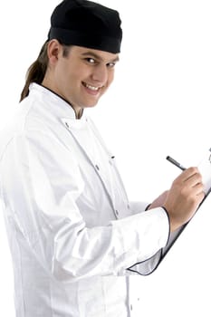 caucasian chef maintaining menu against white background