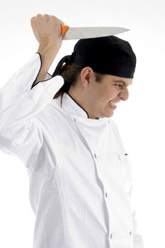 angered chef posing with knife against white background