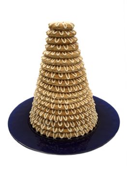 Traditional Scandinavian tower cake (kransekake) made from baked marzipan, decorated with icing