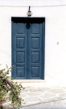 Fragment of a house with blue door