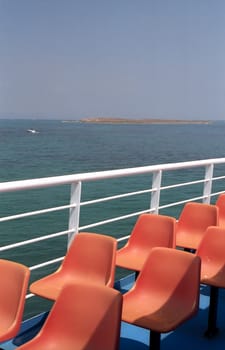 Deck of the boat with red seats