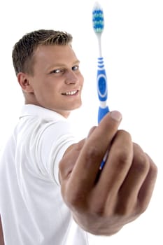 man showing his toothbrush on an isolated white background