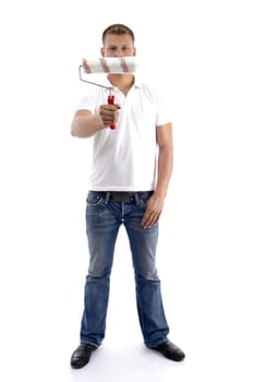 young guy holding painting brush on an isolated white background