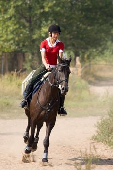 Girl in red t-shirt on riding horse