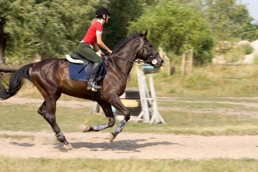 Woman in helmet riding on horse