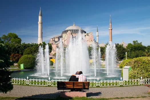 teen moslem couple sitting near of Hagia Sophia mosque