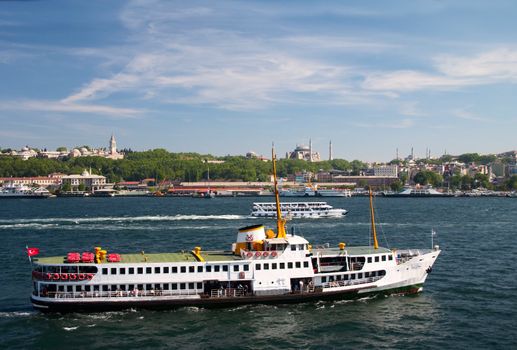 pleasure boat in Bosporus against a background of mosques