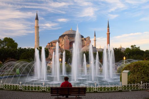 people sitting by the fountain near of Hagia Sophia in Istanbul