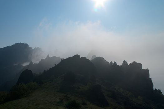 The sun lighting up the mountain ridge and a valley