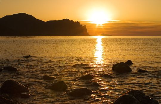 Bright morning sun lighting up the rocks and the sea