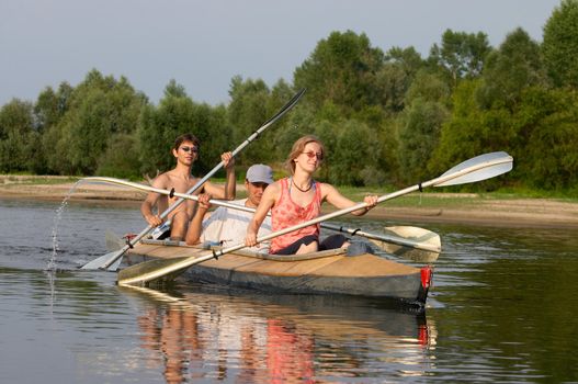 peoples travelling on canoe across the river