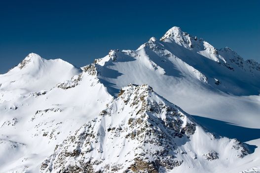 Rocks and mountain peak covered by snow