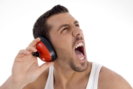 young guy enjoying rock music with full volume against white background