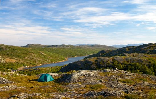 green tent on a fiord coast in north norway