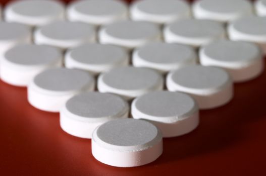 Macro of pills on red background. Shallow DOF