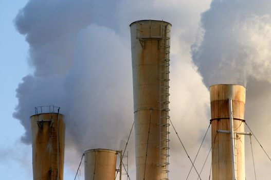 clouds of smoke from factory pipes making air pollution