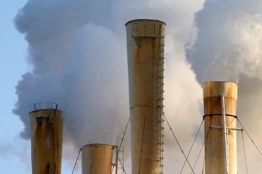 clouds of smoke from factory pipes making air pollution