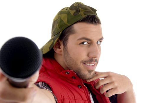 young caucasian offering his microphone with white background